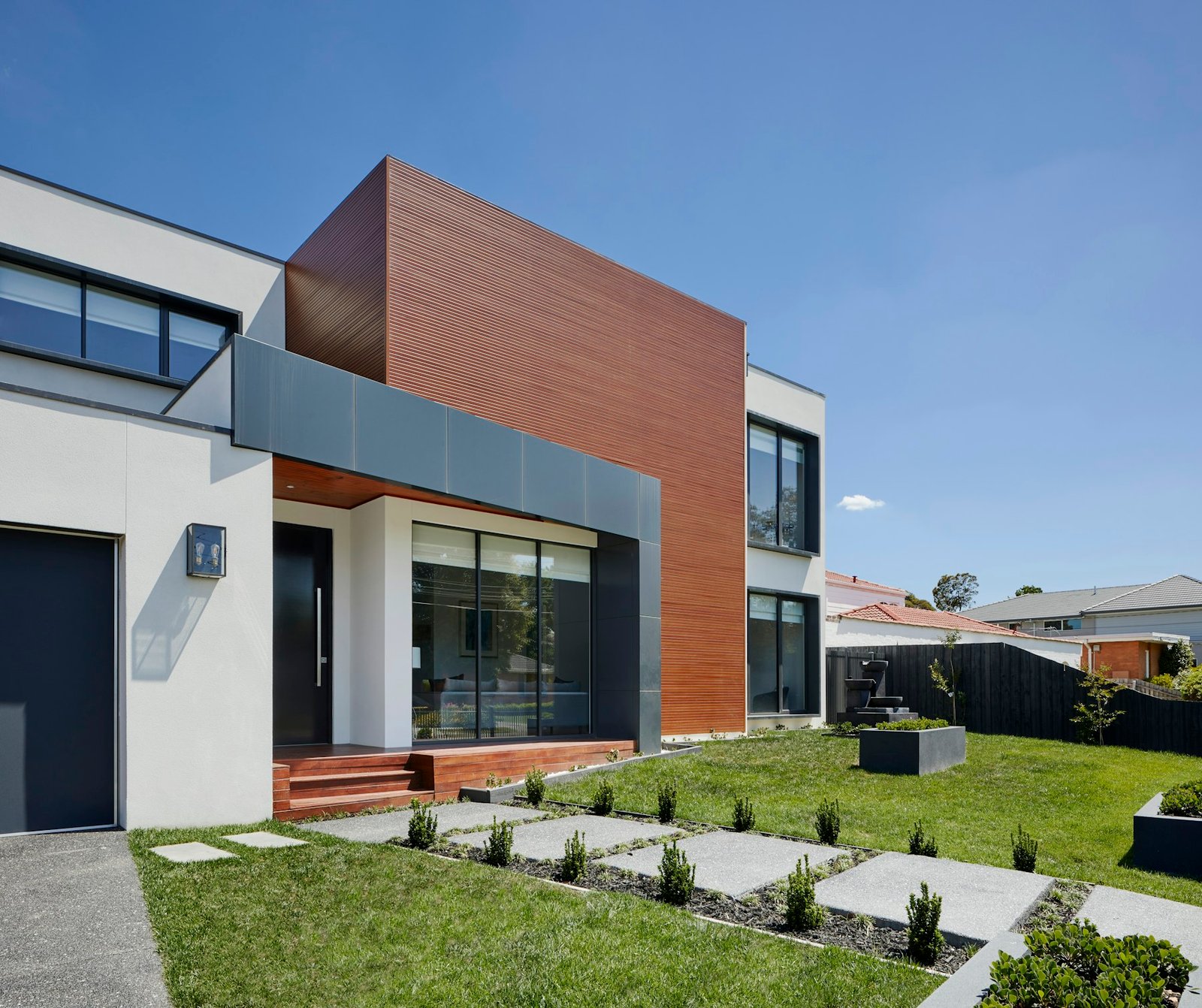Modern home with white stucco, wood siding and metal panels